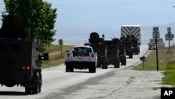 FILE - Air Force personnel escort a nuclear warhead removed from a silo in Montana, Aug. 24, 2023. The weapons are located on private land across the state, and because of their age they must regularly be removed for maintenance. (U.S. Air Force via AP)