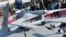 In this Thursday, Nov. 15, 2012 photo, visitors look at Pakistan-made unmanned aircraft at defense exhibition in Karachi, Pakistan. Pakistan is secretly racing to develop its own armed drones, frustrated with U.S. refusals to provide the aircraft, but is 
