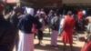 Some Zimbabweans waiting for cash outside a finance institution in the country. (Photo: Patricia Mudadigwa)