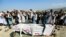 FILE - Relatives and residents pray near a coffin during a funeral ceremony of one of the victims after a drone strike, in Khogyani district of Nangarhar province, Afghanistan Sept. 19, 2019.