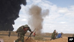 Rebels run for cover during clashes with pro-Gaddafi forces between Ras Lanuf and Ben Jawad, March 9, 2011