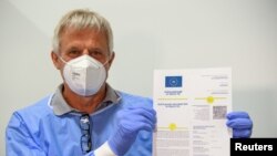 Doctor Christoph Borch shows the new digital COVID-19 vaccination passport COVPASS in Potsdam, Germany, May 27, 2021.