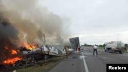 Restos humeantes de un accidente entre un camión y una furgoneta ocurrido en una carretera del estado mexicano de Tamaulipas el 14 de mayo de 2023.