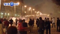 Police fire tear gas outside presidential palace as tens of thousands of protesters march against President Morsi.