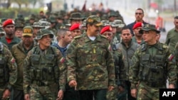 Venezuelan President Nicolas Maduro, center, walks with Defense Minister Vladimir Padrino Lopez, right, and troops during military exercises in Caracas on Jan. 22, 2025. (Venezuelan Presidency Press Office via AFP)