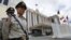 Cambodian police officers stand guard in front of the Peace Palace ahead of the ASEAN Summit and related meetings in Phnom Penh, Cambodia, November 17, 2012.