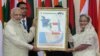 Bangladesh’s Prime Minister Sheikh Hasina, right, and Indian Prime Minister Narendra Modi hold a location map of Indian Economic Zones during an agreement program in Dhaka, Bangladesh, June 6, 2015.
