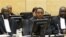 Former Kenyan Minister of Industrialization Henry Kiprono Kosgey, center, sits in the courtroom of the International Criminal Court (ICC) in The Hague, Netherlands, Sept. 1, 2011