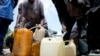 People sell black market fuel on the street in Lagos, Nigeria, May 30, 2023.