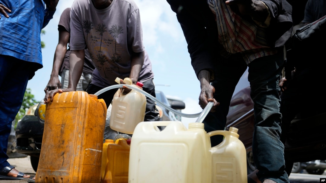 People sell black market fuel on the street in Lagos, Nigeria, May 30, 2023.