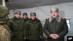 FILE: Belarus President Alexander Lukashenko, right, with military top officials at Obuz-Lesnovsky , Belarus, Friday, Jan. 6, 2023. Belarusian Defense Minister Viktor Khrenin is cenere, and the State Secretary of the Security Council Alexander Volfovich is second left.