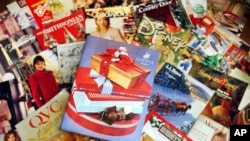 FILE - A selection of holiday season catalogs is pictured in Portland, Maine. 