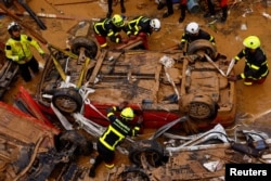 Firefighters search for possible victims inside a car that was stranded in a tunnel after heavy rains in Alfafar, in Valencia, Spain, on Nov. 1, 2024.