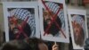 FILE - Indian activists carry placards of the leader of the Pakistan-based Jaish-e-Mohammad group, Masood Azhar, during a protest denouncing an attack on the Indian air force base in Pathankot, in Mumbai, India, Jan. 4, 2016.