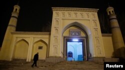 FILE - A man arrives at the Id Kah Mosque for morning prayers in Kashgar, Xinjiang Uighur Autonomous Region, China, March 23, 2017. 