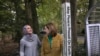 Heba Macksoud, left, of Princeton, New Jersey, and Sheryl Olitzky, members of the Sisterhood of Salaam Shalom, stand near a Peace Pole, with English and Arabic writings, in North Brunswick, New Jersey, Oct. 17, 2019.