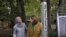 Heba Macksoud, left, of Princeton, New Jersey, and Sheryl Olitzky, members of the Sisterhood of Salaam Shalom, stand near a Peace Pole, with English and Arabic writings, in North Brunswick, New Jersey, Oct. 17, 2019.