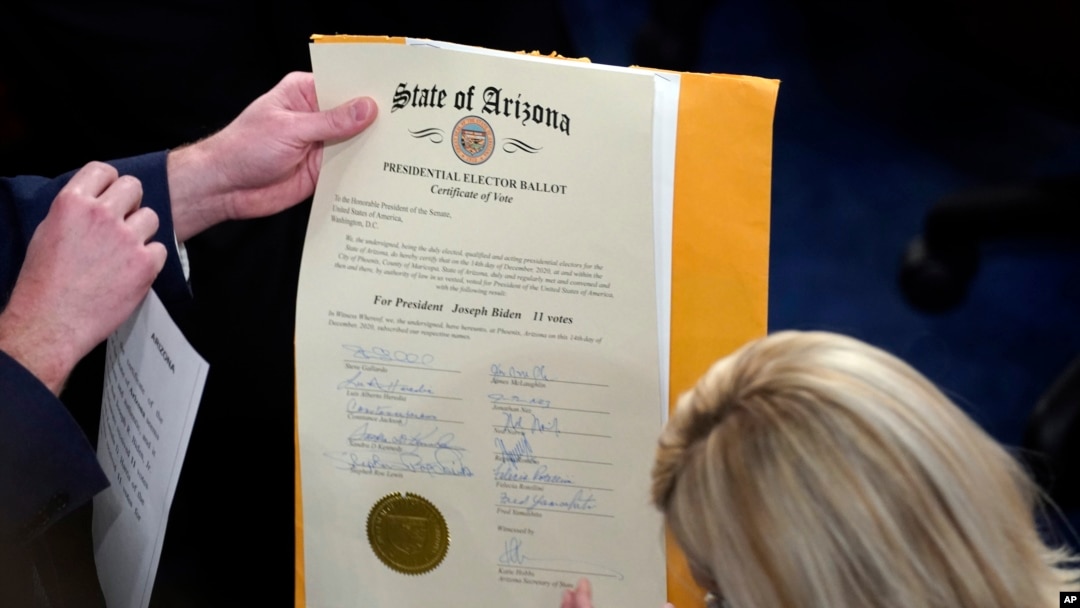 FILE - The certification of Electoral College votes for the state of Arizona is unsealed during a joint session of the House and Senate convenes to confirm the electoral votes cast in November's election, at the Capitol, Jan 6, 2021.