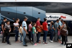 Central American migrants prepare to board a bus as they voluntarily return to their countries, in Ciudad Juarez, Mexico, July 2, 2019.