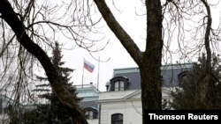 FILE - A national flag of Russia flies on the Russian embassy in Prague.