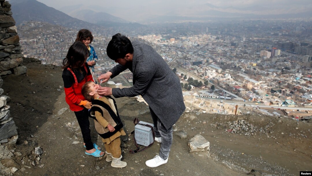 FILE - A boy receives polio vaccination drops during an anti-polio campaign in Kabul, Afghanistan, March 14, 2018.