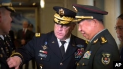 U.S. - China: U.S. Army Chief of Staff Gen. Mark Milley, left, introduces members of his staff to China's People's Liberation Army (PLA) Gen. Li Zuocheng, right, during a welcome ceremony at the Bayi Building in Beijing, Tuesday, Aug. 16, 2016. 