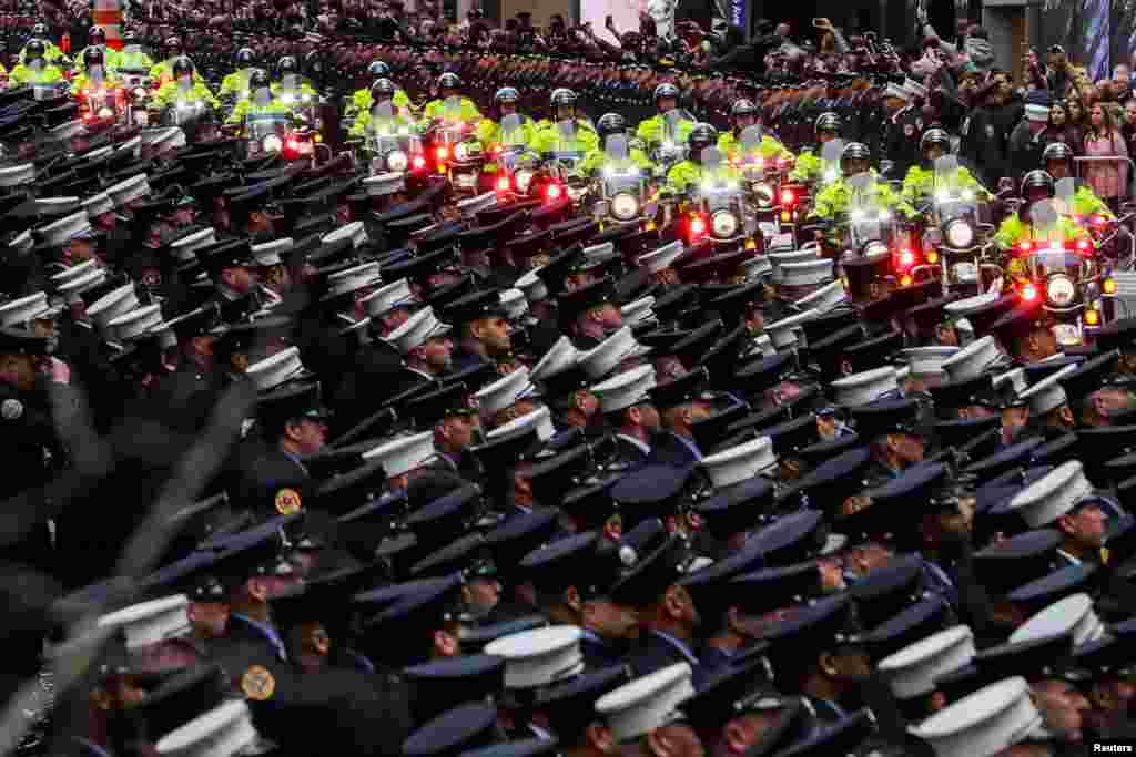 New York City Department (FDNY) officers attend a funeral service of FDNY firefighter and U.S. Marine Christopher Slutman, in New York City, U.S.