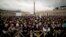 Visitors wait for the chimney smoke in St. Peter's Square during the second day of the conclave to elect a new pope, at the Vatican, Mar. 13, 2013.