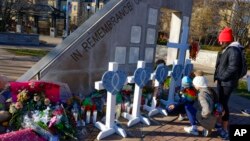 A family visits a memorial in Waukesha, Wisconsin, Nov. 23, 2021. 