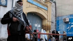 Security guards stand alert around schools and colleges following an attack on Bacha Khan University, in Peshawar, Pakistan, Jan. 21, 2016. 