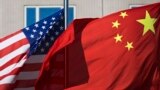 U.S. flag and China's flag flutter in winds at a hotel in Beijing, Sept. 5, 2012.