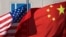 U.S. flag and China's flag flutter in winds at a hotel in Beijing.