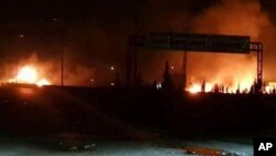 This photo released on May 9, 2018, by the Syrian official news agency SANA, shows flames rising after an attack in an area known to have numerous Syrian army military bases, in Kisweh, south of Damascus, Syria.