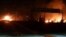 This photo released on May 9, 2018, by the Syrian official news agency SANA, shows flames rising after an attack in an area known to have numerous Syrian army military bases, in Kisweh, south of Damascus, Syria.