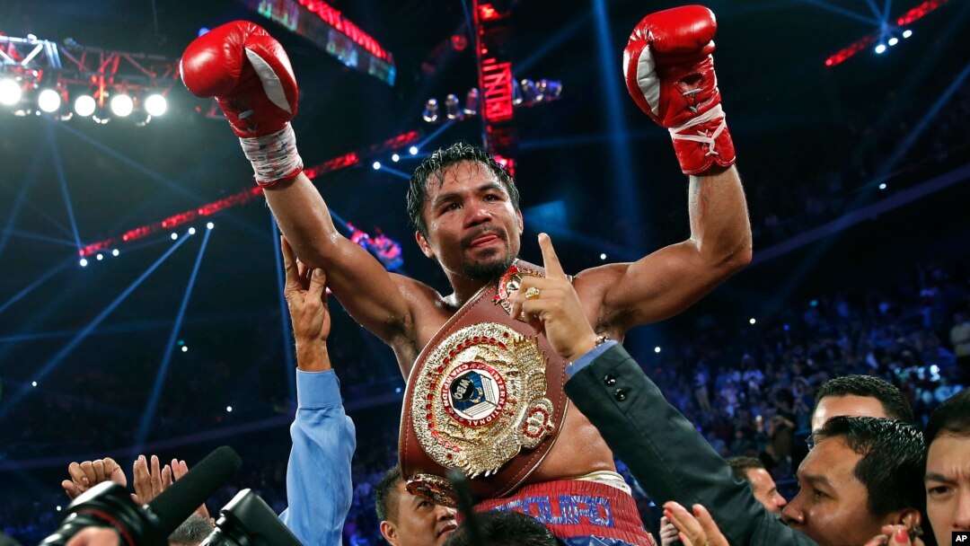 Manny Pacquiao from the Philippines wears the champion's belt after defeating Brandon Rios of the United States in the WBO international welterweight title fight, Nov. 24, 2013, in Macau.
