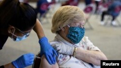 FILE - A patient receives a COVID-19 vaccine booster during a Pfizer-BioNTech vaccination clinic in Southfield, Michigan, September 29, 2021.