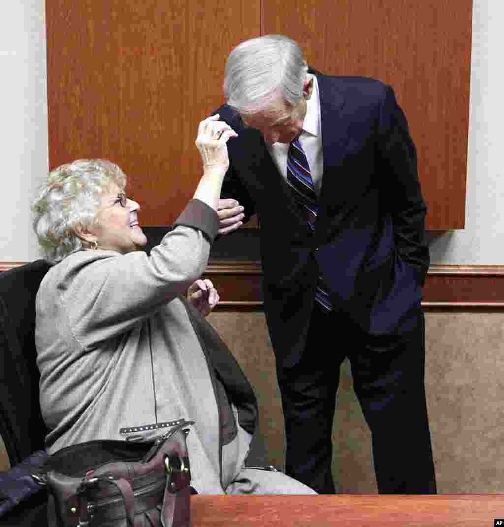 Carol Paul, wife of Republican presidential candidate Rep. Ron Paul, R-Texas, fixes his hair before the North Dakota caucus, Tuesday, March 6, 2012 in Fargo, N.D. (AP Photo/Charles Rex Arbogast)