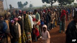 People seeking medical care wait in line outside a Doctors Without Borders health post, in a camp housing more than 40,000 people displaced by violence, at Mpoko Airport in Bangui, Central African Republic, Dec. 21, 2013.