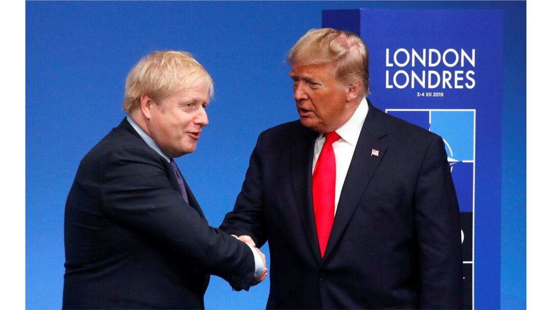 FILE - Britain's Prime Minister Boris Johnson shakes hands with U.S. President Donald Trump during a welcoming ceremony at the NATO leaders summit in Watford, Britain, Dec. 4, 2019.