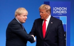 FILE - Britain's Prime Minister Boris Johnson shakes hands with U.S. President Donald Trump during a welcoming ceremony at the NATO leaders summit in Watford, Britain, Dec. 4, 2019.