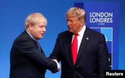 FILE - Britain's Prime Minister Boris Johnson shakes hands with U.S. President Donald Trump during a welcoming ceremony at the NATO leaders summit in Watford, Britain, Dec. 4, 2019.