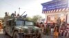 FILE - Taliban fighters stand guard at a checkpoint in Kunduz city, northern Afghanistan, Aug. 9, 2021. As the Taliban took control of Afghanistan in a swift power grab, thousands of Afghans have been looking for ways to escape.
