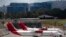 Aircraft from the Avianca airline sit parked at La Aurora airport in Guatemala City, Tuesday, March 17, 2020. 