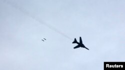 FILE - A warplane loyal to Syria's President Bashar al-Assad fires rockets during an air strike in eastern Al-Ghouta, near Damascus January 25, 2015.