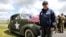 U.S. World War II veteran Jack Hamlin, 93 years old from Springfield, Missouri, who served with the Rescue Flotilla 1, U.S.C.G, poses beside a staff car in Carentan, on the Normandy coast, June 4, 2014. 