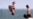 People jump off the Kerferd Road Pier as people cool off in the heatwave conditions at Melbourne's Albert Park Beach on November 22, 2024 (Photo by William WEST / AFP)