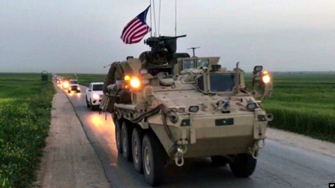 This Friday, April 28, 2017 still taken from video, shows U.S. forces patrolling on a rural road in the village of Darbasiyah, in northern Syria. 
