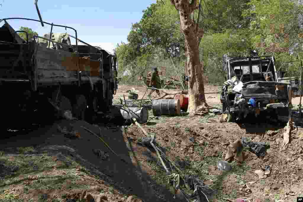 A Malian soldier walks into a military camp used by radical Islamists and bombarded by French warplanes, in Diabaly, Mali, January 21, 2013.