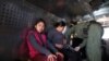 FILE - Migrants from Guatemala, sit in a truck after surrendering to U.S. Border Patrol Agents in El Paso, Texas, March 5, 2019. U.S. Border Patrol intercepted a similar truck with 32 migrants in Arizona this week.