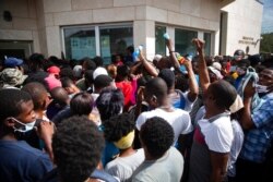 Haitians gather in front of the U.S. Embassy amid rumors on radio and social media that the U.S. will be handing out exile and humanitarian visas, in Port-au-Prince, Haiti, July 9, 2021, two days after President Jovenel Moise was assassinated.